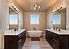 The Main bathroom that is adjacent to the Main bedroom is large and luxurious. With his and her sinks, toilet, vanity, walk-in shower, large bathtub and a large walk-in closet.