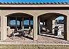 Back patio with furniture and grill.