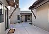 Beyond the iron gate is a beautiful private courtyard with front door access to the home and back door access to the casita. 