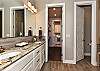 View of the Main bathroom with a spacious closet and access to the laundry room