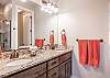 The Main bathroom that is adjacent to the Main bedroom is large and luxurious. With his and her sinks, toilet, vanity, walk-in shower and a large walk-in closet.