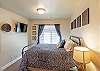 Bedroom 2 is furnished with a Queen Bed and includes a walk-in closet