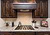 The Kitchen Stove includes five burners and features an elegant hood and fan.