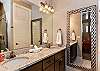 The Main bathroom that is adjacent to the Main bedroom is large and luxurious. With his and her sinks, toilet, vanity, walk-in shower, and a large walk-in closet.