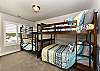Bedroom 3 is furnished with 4 Full Beds configured into two bunk beds and includes a walk-in closet.