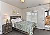 Bedroom 4 is an uneclosed loft area with Queen bed, satellite TV and access to front patio.