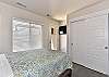 Side view of bedroom 4 showing access to front patio and TV.