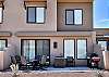 The Back View highlights the back of our beautiful home and emphasizes the spacious cement patio and outside dining table.
