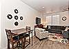 The living room is designed as an open floor plan and is a great gathering place for meals, games, or watching TV during your stay. 