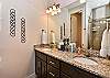 Main bathroom includes his and her sinks, toilet, large vanity and walk-in shower. 