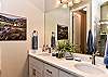 The Main bathroom that is adjacent to the Main bedroom is large and luxurious. With his and her sinks, toilet, vanity, walk-in shower and a large walk-in closet.
