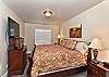 The Upstairs Main bedroom is furnished with a plush King be, private satellite TV, and walk-in closet. 