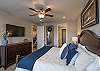 The Main bedroom is furnished with a plush King bed, private TV, and walk-in closet. 