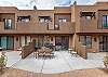 The Back View highlights the back of our beautiful home and emphasizes the spacious cement patio and outside dining table.