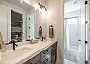 Arches Bathroom includes a tub/shower combo, his and hers sinks, toilet, and vanity.
