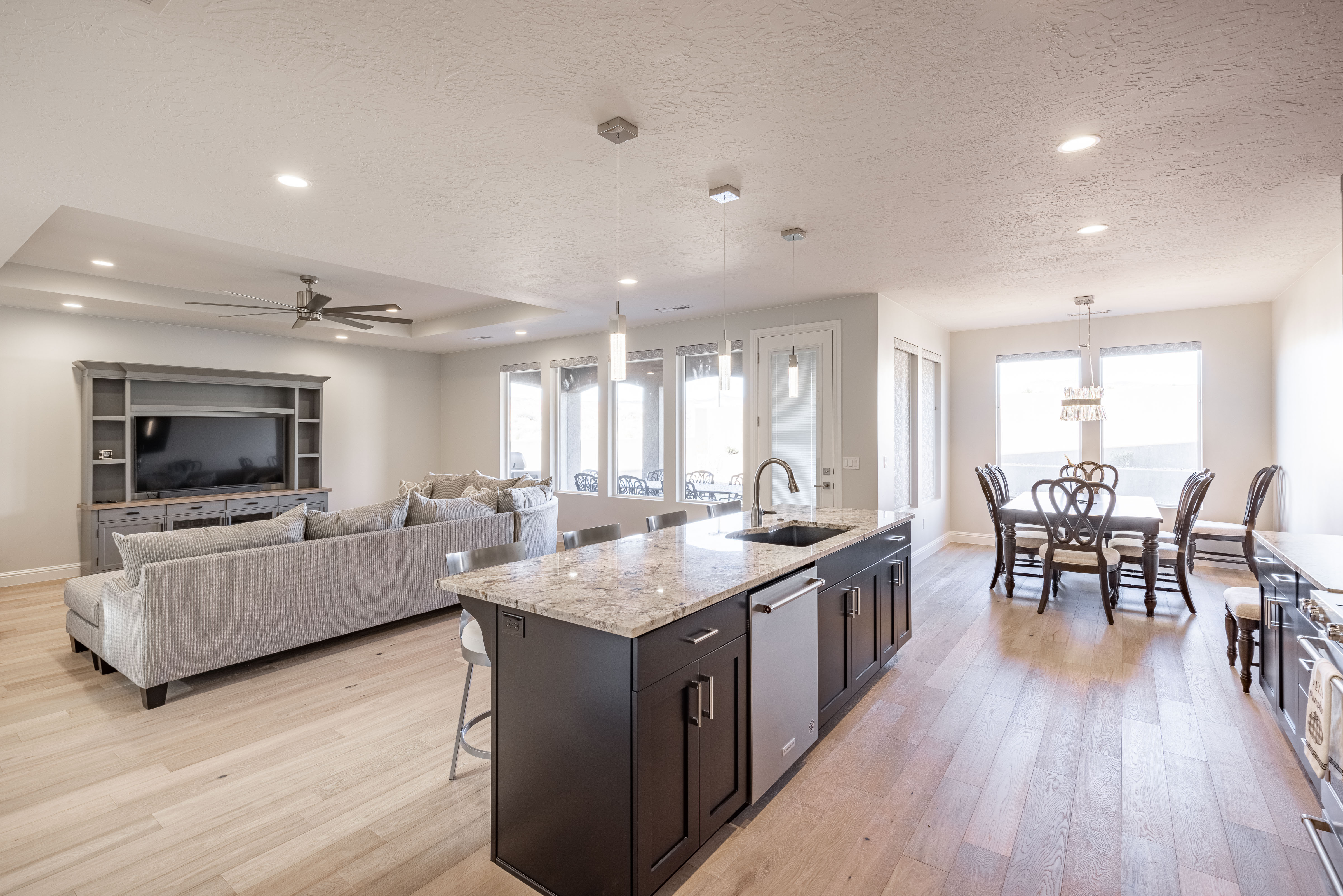 Side view of kitchen showing off the beautiful counter tops and stainless-steel appliances. 
