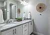 The Main Bathroom includes his and her sinks, toilet, vanity and walk-in shower.