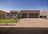 The beautiful home overlooks hole #1 at The Ledges Golf Club and has a three car garage, casita, and views of Snow Canyon. 