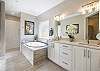 Enjoy the large walk-in shower or relax in the oversized soaking tub that adjoins the primary bedroom.