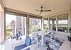 The back deck includes a firepit table, multiple seating areas, and dining table.