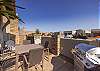 The front courtyard has a grill and plenty of seating for your guests. 