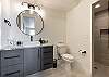 Bathroom 3 is designed with luxury cabinets and a walk in shower.