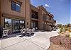 The Back View highlights the back of our beautiful home and emphasizes the spacious cement patio and outside dining table.