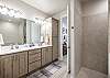 The main bathroom that is adjacent to the main bedroom is large and luxurious. With his and her sinks, toilet, vanity, walk-in shower, large bathtub and a large walk-in closet.