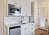 Bedroom 2 kitchenette includes a sink, dishwasher, and microwave. 