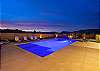 Turn on the pool lights and swim while watching the sunset. 