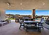 The back view highlights the spacious back patio and large BBQ grill area.