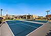 This home is equipped with a pickleball/basketball court. 