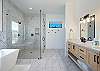 The second main bathroom includes his and her sinks, a walk-in shower, a full-size bathtub with a great view , and a large walk-in closet.