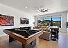 The game room is a great place to gather, play and relax. It is equipped with a pool table, shuffleboard, a Pac-man arcade game, large couch, Smart TV, and a kitchenette. Its huge windows provide a beautiful view of the backyard amenities and a sliding door so you can walk out to the grill and pool area.