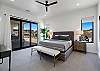 Bedroom 2 has private access to the back patio and includes a King bed, private TV, and closet. 