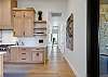 On the far right of the kitchen is the hallway that will lead to the main bedroom and game room. 