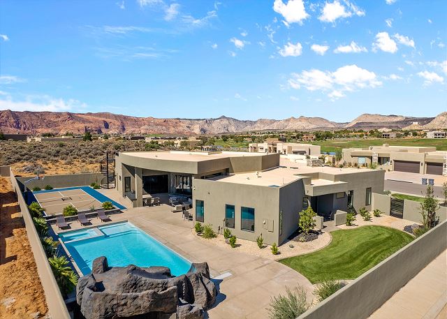 The Back View highlights the private pool, hot tub, basketball court, and grilling area, as well as the beautiful mountains surrounding our home.