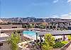 The upstairs patio view of the pool amenities and beautiful mountains.