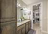 The main bathroom that is adjacent to the main bedroom is large and luxurious. With his and her sinks, toilet, vanity, walk-in shower, large bathtub and a large walk-in closet.