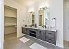 The main bathroom that is adjacent to the main bedroom is large and luxurious. With his and her sinks, toilet, vanity, walk-in shower, large bathtub and a large walk-in closet.