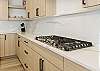 Gas stove and beautiful granite countertops. 