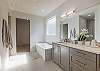 The main bathroom that is adjacent to the main bedroom is large and luxurious. With his and her sinks, toilet, vanity, walk-in shower, large bathtub and a large walk-in closet.