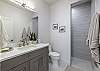 Bathroom 2 includes a large walk-in shower, sink, toilet, and vanity.