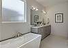 Let your worries soak away while relaxing in the large main bathtub .