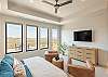 The main bedroom features its own private exterior entrance with direct access to the outdoor seating area and hot tub.
