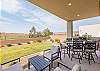 The enclosed private backyard offers stunning views of the red rock cliffs and lush golf course, along with a spacious patio and Weber Genesis grill for all your outdoor cooking needs.
