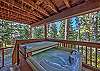 The hot tub is located on the deck off of the family room.