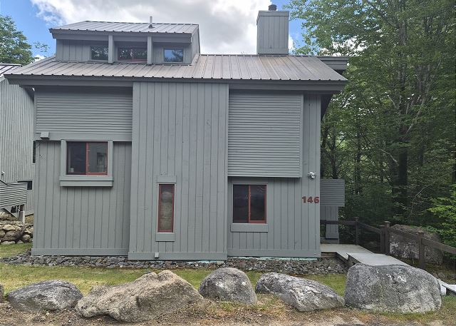 Clearbrook 146, a freestanding home with 5 easy steps down from the parking area to the entry door.