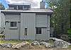 Clearbrook 146, a freestanding home with 5 easy steps down from the parking area to the entry door.