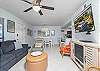Ceramic tile throughout, coastal-chic furnishings, sofa sleeper, recliner and occasional chair, and a large TV with DISH Satellite service for movie nights at home.